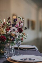 Wedding bouquet of flowers in a vase on a reception table for bride and groom 