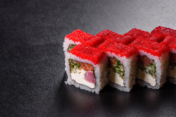 Traditional delicious fresh sushi roll set on a black background