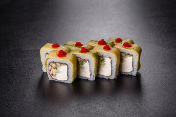 Traditional delicious fresh sushi roll set on a black background