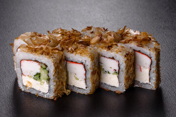 Traditional delicious fresh sushi roll set on a black background
