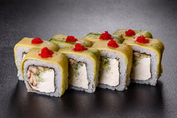 Traditional delicious fresh sushi roll set on a black background