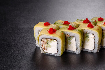 Traditional delicious fresh sushi roll set on a black background