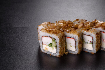 Traditional delicious fresh sushi roll set on a black background