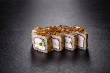Traditional delicious fresh sushi roll set on a black background