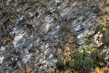 Seamless black rock texture background close-up.