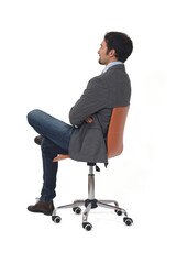 rear view of a man with blazer sitting on chair arms and legs crossed on white  background