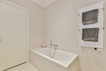 Empty bathtub in light bathroom