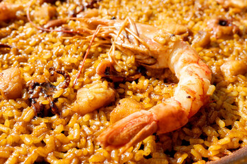 Detail of a prawn on a Valencian seafood paella, typical Spanish food.