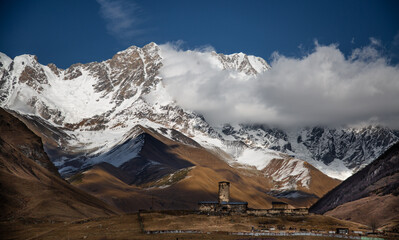  Caucasus mountains with clouds and fortified towers