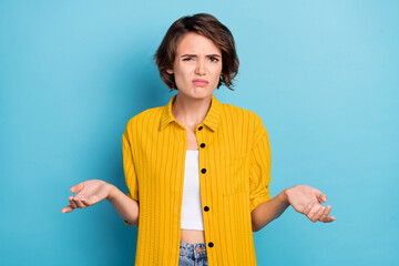 Photo of speechless confused puzzled lady shrug shoulders wear yellow shirt isolated blue color...