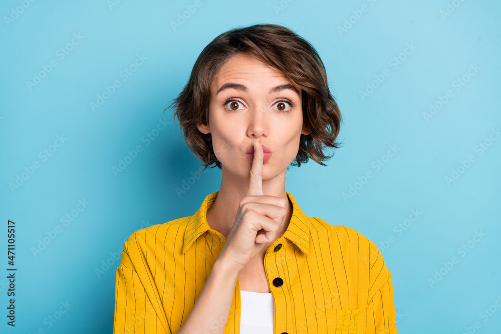 Sticker photo of secret millennial brunette lady finger lips wear yellow shirt isolated on blue color backgr