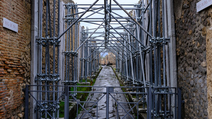 Italy, Pompeii - October 2021:road with scaffolding. works in c. Excavations of Pompeii [...]