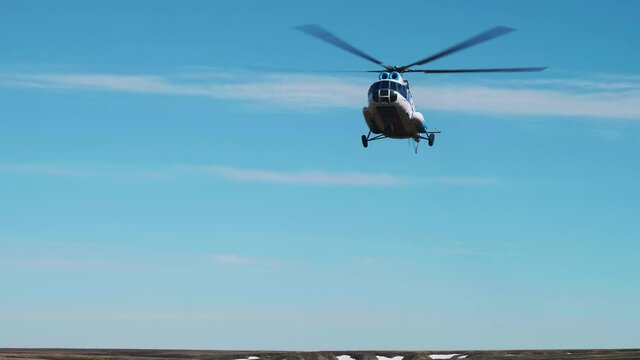 Helicopter flies in the sky and starts landing. Airforce.