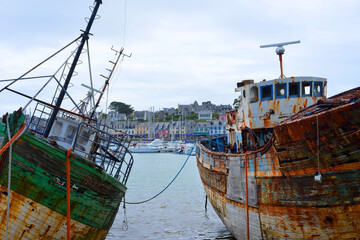 Camaret sur Mer, France, view to the village ancient fish trawlers rotting at the Harbor