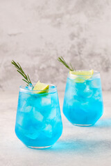 Refreshing blue drink or cocktail with ice