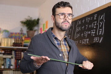 Severe school teacher holding stick