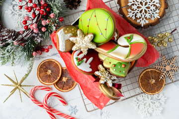 Flat lay of Christmas gingerbread cookies with festive icing and Christmas decoration on the white background. Merry Christmas and Happy New Year.