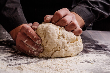 pastry chef  prepares yeast dough for pizza pasta.