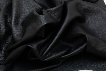 Black folded natural cow leather on the wooden table