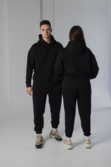 Couple posing in studio wearing black hoodie - 471117121
