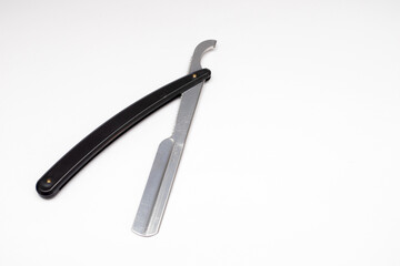 Black straight razor on a white background