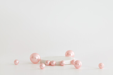 White marble podium on the white background with pink pearls. Podium for product, cosmetic...