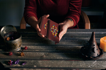 Pythoness woman shuffles tarot cards
