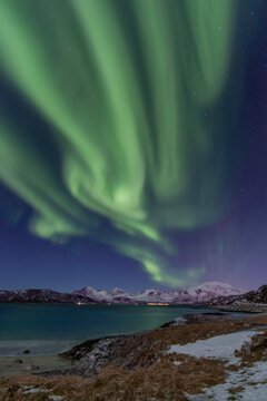 Aurora borealis over fjord in Norway © Monika