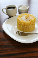 Corn couscous with coconut and cup of coffee. Traditional Brazilian breakfast, especially in northeastern Brazil.
