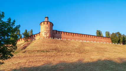Nizhny Novgorod, the Kremlin. a sunny summer day with a blue sky. A long brick wall with a tower