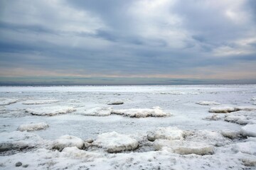 Winter seaside landscape - beach and frozen Baltic Sea near Mikoszewo, Zulawy Wislane, Poland