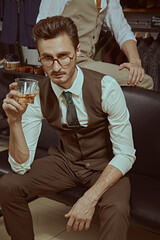 italian man drinks whiskey