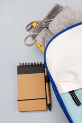 backpack with pencil case on paper background