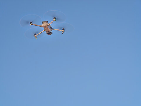 Grover, CO, USA - November 22, 2021: Mavic 3, an advanced, foldable consumer drone by DJI is flying against blue sky.