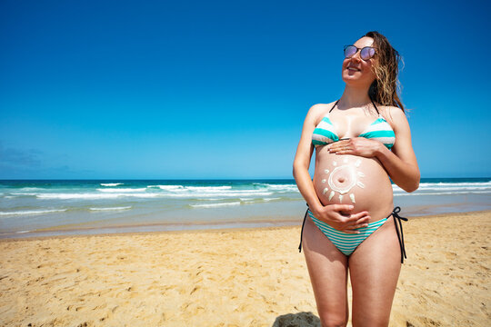 Sun image drawn on pregnant woman belly concept