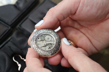 vintage mechanical pocket watch for a gentleman with a window through which you can see the working...