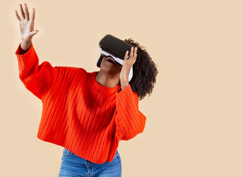 african american woman uses virtual reality glasses in studio - Powered by Adobe