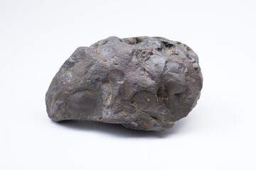 Meteorite isolated on white background. A piece of rock specimen formed in outer space in the early...