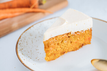 Carrot cake with cream cheese on top on a bright white backround