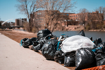 River Trash clean up. Trash bags in a pile. City clean up. 