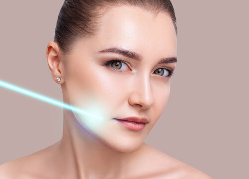 Cosmetics laser ray on beautiful female face.