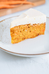 Carrot cake with cream cheese on top on a bright white backround
