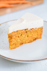 Carrot cake with cream cheese on top on a bright white backround