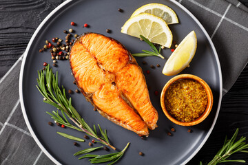 baked salmon steak on a plate, top view