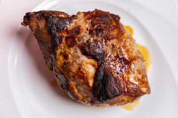 Roast pork loin on a white plate, close-up