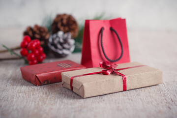 Mini christmas gifts on wooden background with warm and cold tones