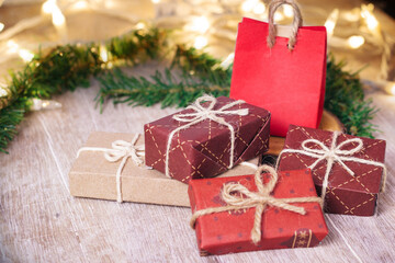 Mini christmas gifts on wooden background with warm and cold tones