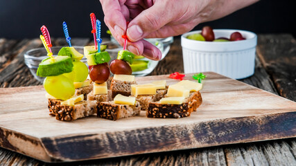 Finger food appetizer with hand taking one 