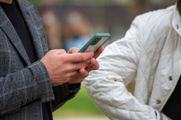 Young man holding a mobile phone. Looking at the phone.