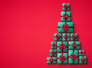 Green gift boxes with red bows in Christmas tree shape.